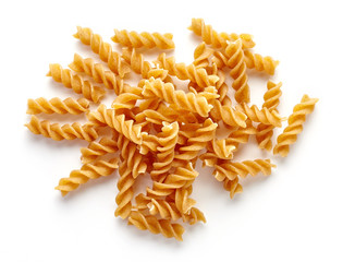 whole grain pasta isolated on white, from above - obrazy, fototapety, plakaty