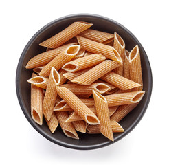 whole grain pasta in bowl isolated on white, from above
