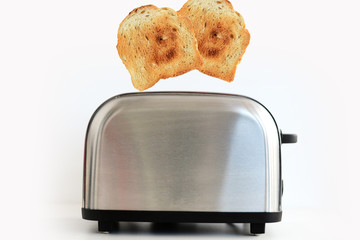 Roasted toast bread popping up of stainless steel toaster