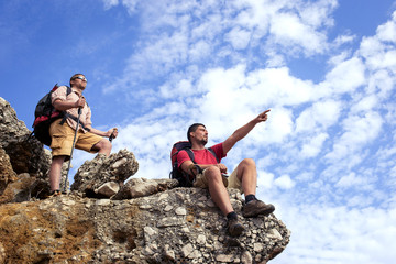 Two men in a hike in the mountains with backpacks.