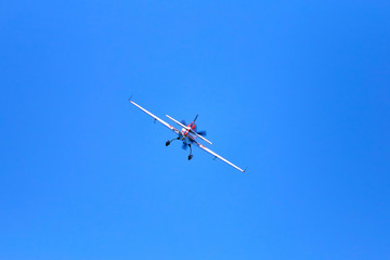 Fototapeta na wymiar Flight of a sport aircraft against a blue sky.