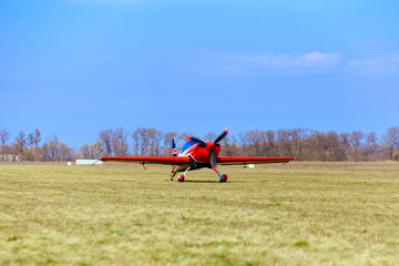 Obraz na płótnie Canvas A sport aircraft on a dirt road on a sunny day.
