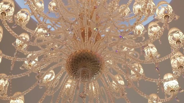 Lights of modern chandelier. Lighting decor. Chandelier close up. Steadicam shot.
