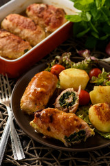 Spinach and cheese pork rolls (roulades) served with vegetables.