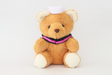 Teddy bear wearing a nurse hat on a white background.