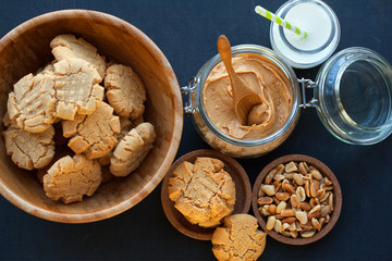 Peanut butter cookies with milk on a black background, selective focus