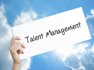 Talent Management Sign on white paper. Man Hand Holding Paper with text. Isolated on sky background