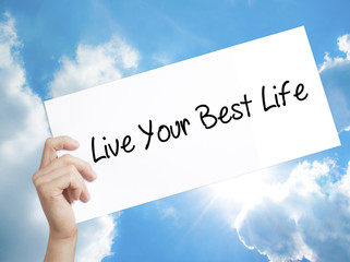 Live Your Best Life Sign on white paper. Man Hand Holding Paper with text. Isolated on sky...