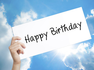 Happy Birthday Sign on white paper. Man Hand Holding Paper with text. Isolated on sky background