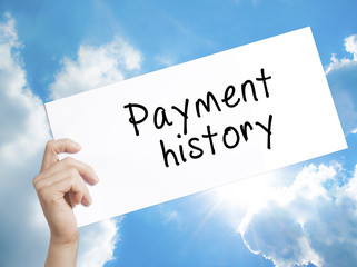 Payment history Sign on white paper. Man Hand Holding Paper with text. Isolated on sky background
