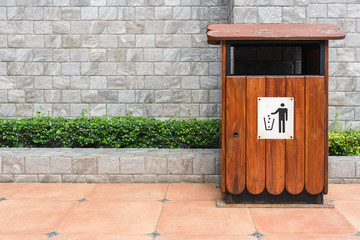 Wooden bin near gray brick wall