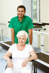 Obraz premium Handsome doctor and his female patient in a wheelchair