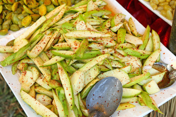 Preserve mango fruit spicy, sprinkle with sugar, chili powder and salt