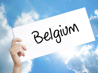 Belgium  Sign on white paper. Man Hand Holding Paper with text. Isolated on sky background