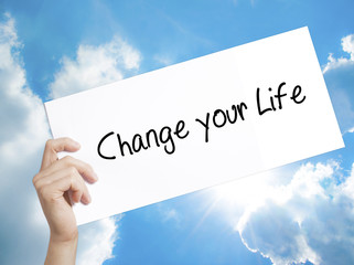 Change your Life Sign on white paper. Man Hand Holding Paper with text. Isolated on sky background