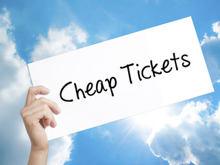 Cheap Tickets Sign on white paper. Man Hand Holding Paper with text. Isolated on sky background