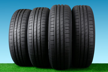 Obraz premium Summer car tyres on grass