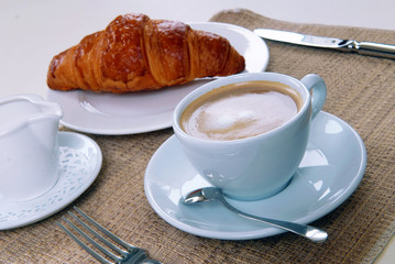 cup of coffee and a croissant