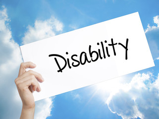 Disability Sign on white paper. Man Hand Holding Paper with text. Isolated on sky background