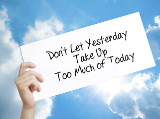 Don't Let Yesterday Take Up Too Much of Today Sign on white paper. Man Hand Holding Paper with...