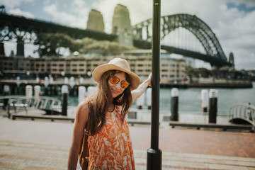 Woman posing in Sydney city with Harbour Bridge in the background