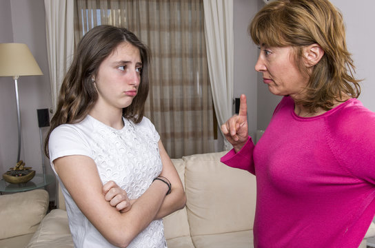 Teen girl is sad because her mother is angry at home.