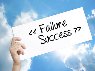 Failure Success Sign on white paper. Man Hand Holding Paper with text. Isolated on sky background