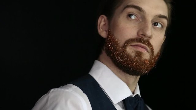 Handsome bearded man with fair skin and trendy ginger beard posing for photographer. Handsome man with fashionable undercut hairstyle posing during photo shoot.