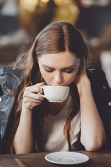 attractive woman with coffee in messy room after party