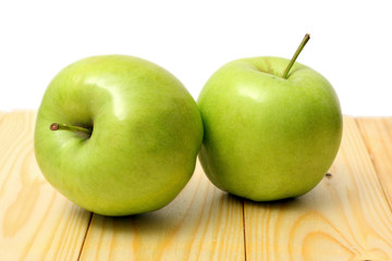 Green apple on wood table isolated on white background