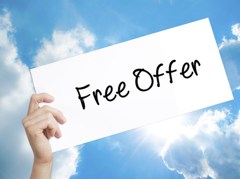 Free Offer  Sign on white paper. Man Hand Holding Paper with text. Isolated on sky background