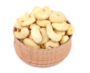 cashew in wood plate isolated on white background