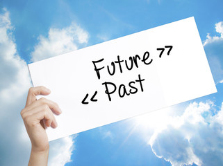 Future - Past Sign on white paper. Man Hand Holding Paper with text. Isolated on sky background.