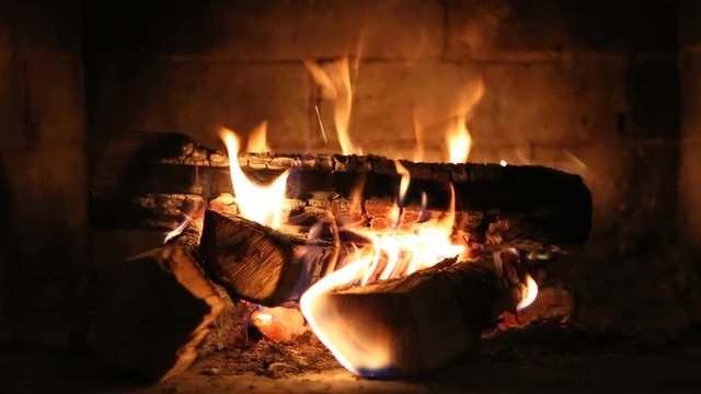 Burning fire In the fireplace. Wood and embers in the fireplace. Detailed fire background, A looping clip of a fireplace with medium size flames
