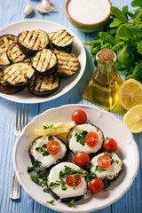 Grilled eggplants with yogurt dip and tomatoes.