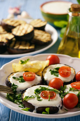Grilled eggplants with yogurt dip and tomatoes.