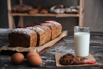 Bread with milk and cookie near eggs