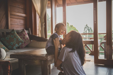 mother and child girl playing