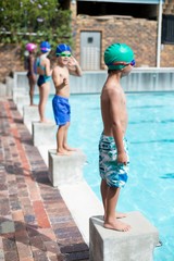 Little girls and boys waiting on start blocks
