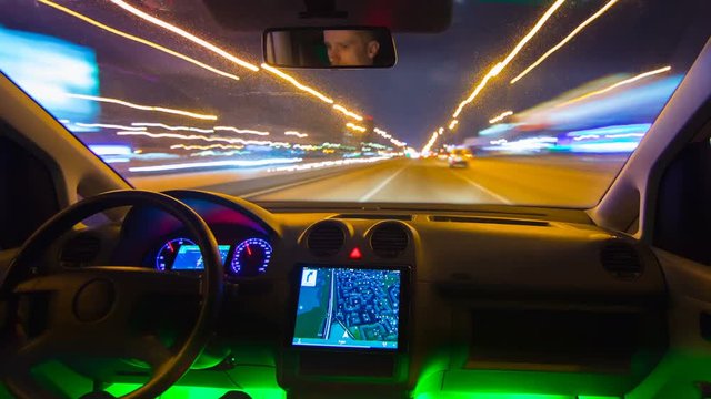 The man drive a car on the night highway. Inside view. Hyperlapse