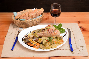 Dish with turkey thigh and side dish of potatoes and zucchini orange pepper

