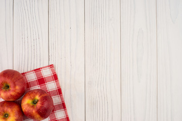 Red apples on the old wooden table.
