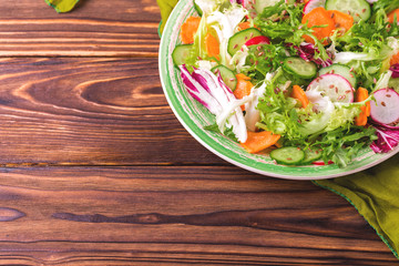 Fresh salad with salad mix, cucumber, radish and carrot
