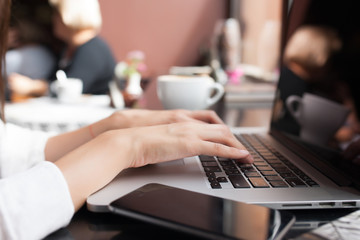 Rear view of a creative female freelancer sitting front laptop