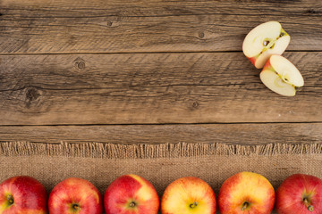 Red apples on the old wooden table.