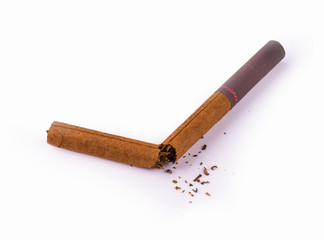 Broken brown cigar on a white background.