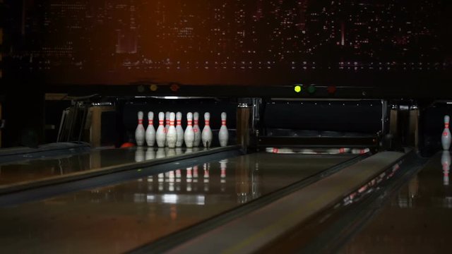Bowling ball knocks down skittles