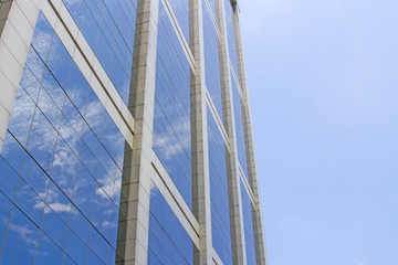 The building reflects with blue sky.