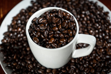 White cup in coffee beans