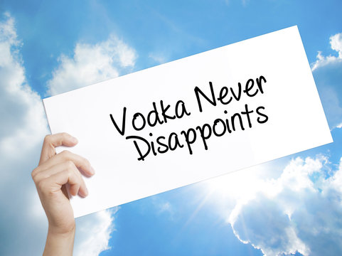 Vodka Never Disappoints Sign on white paper. Man Hand Holding Paper with text. Isolated on sky background